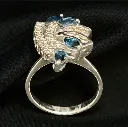 Elegant ring featuring 18-carat white gold, blue sapphires, and diamonds