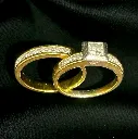 An 18-carat yellow and white Gold handmade wedding set consisting of a nine (9) stone Diamond ring