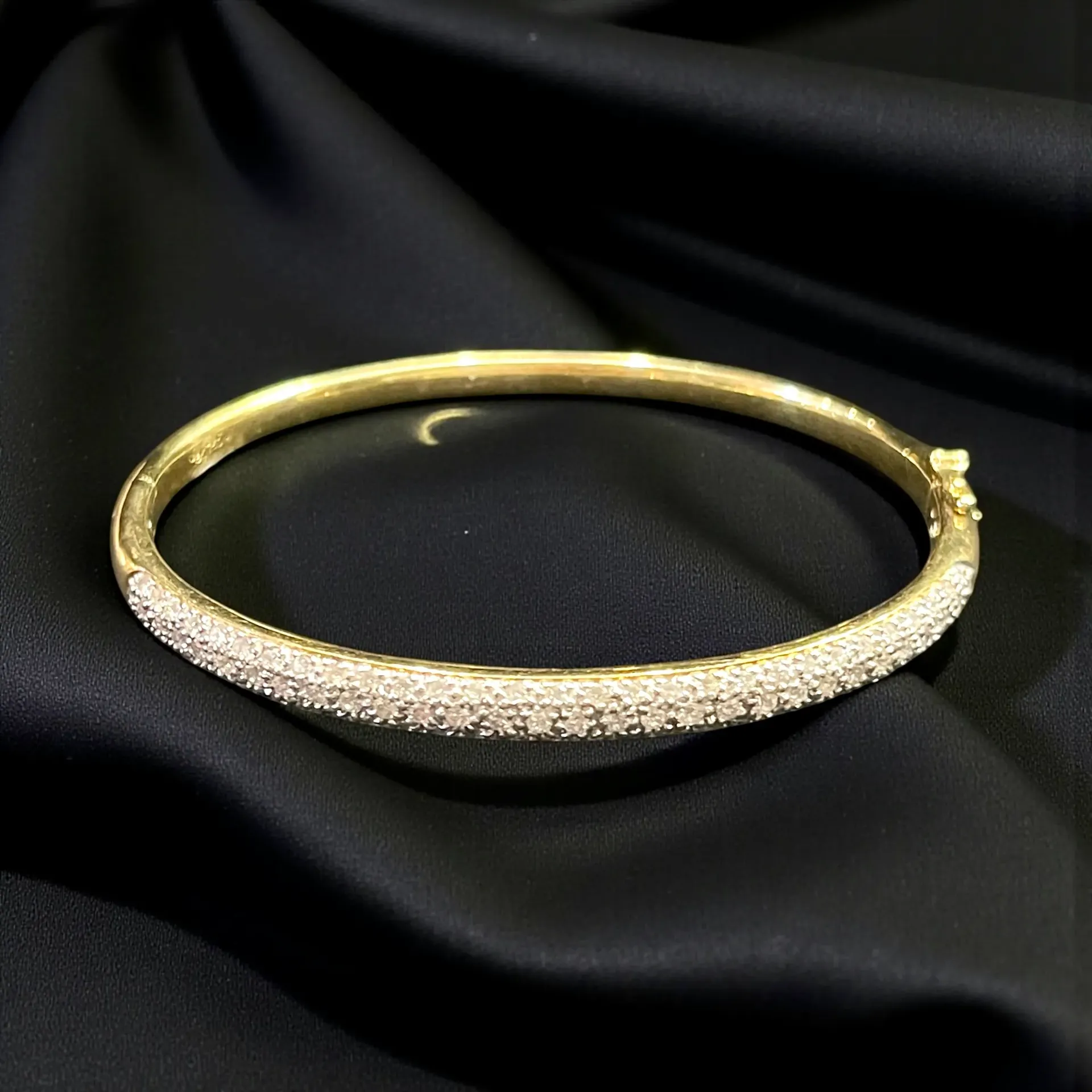An 18-carat yellow Gold and Diamond bangle