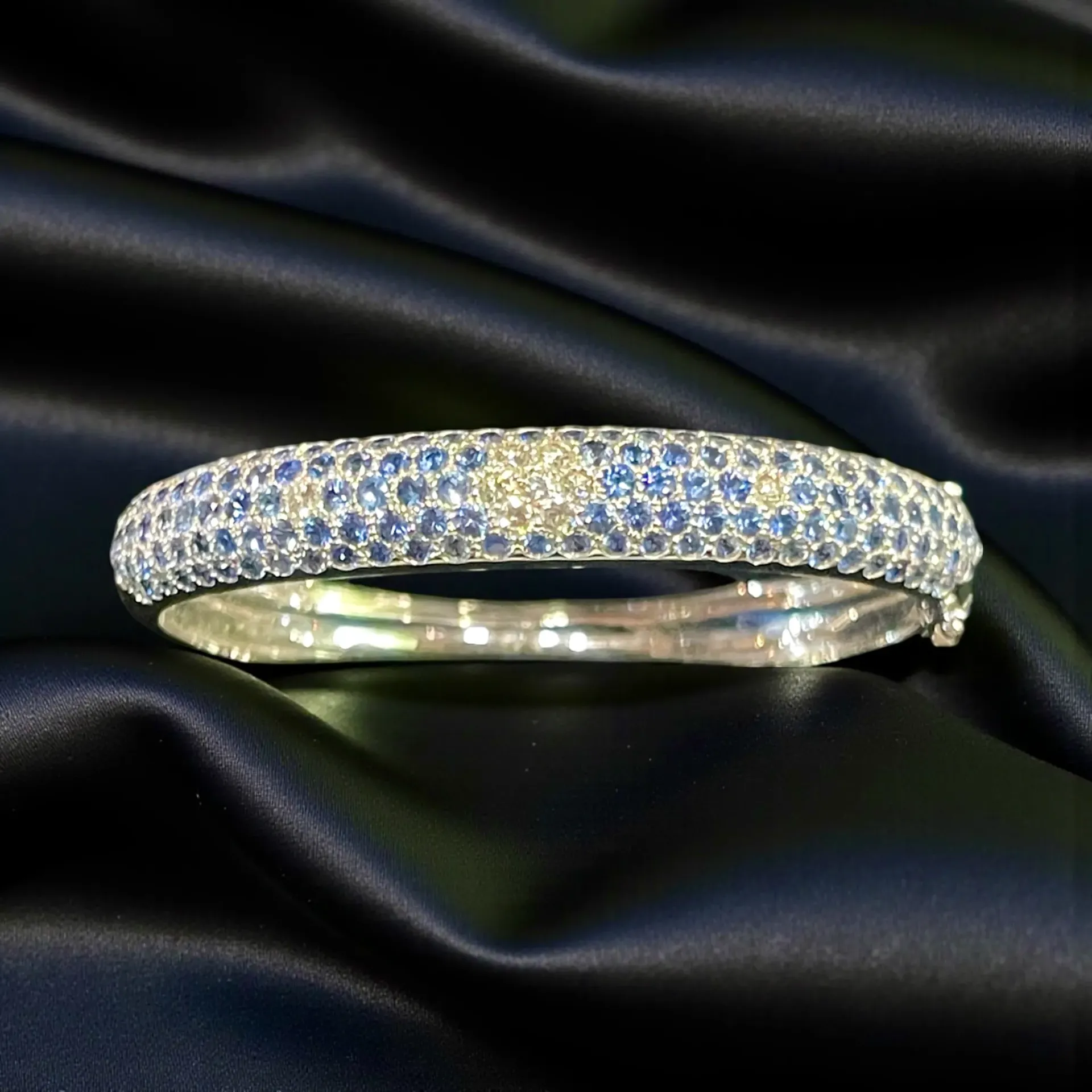 An 18-carat white Gold, Sapphire and Diamond bangle