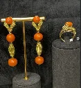 A 14-carat Yellow Gold and Coral dress ring. / A pair of 18-carat Yellow Gold and Coral earrings.
